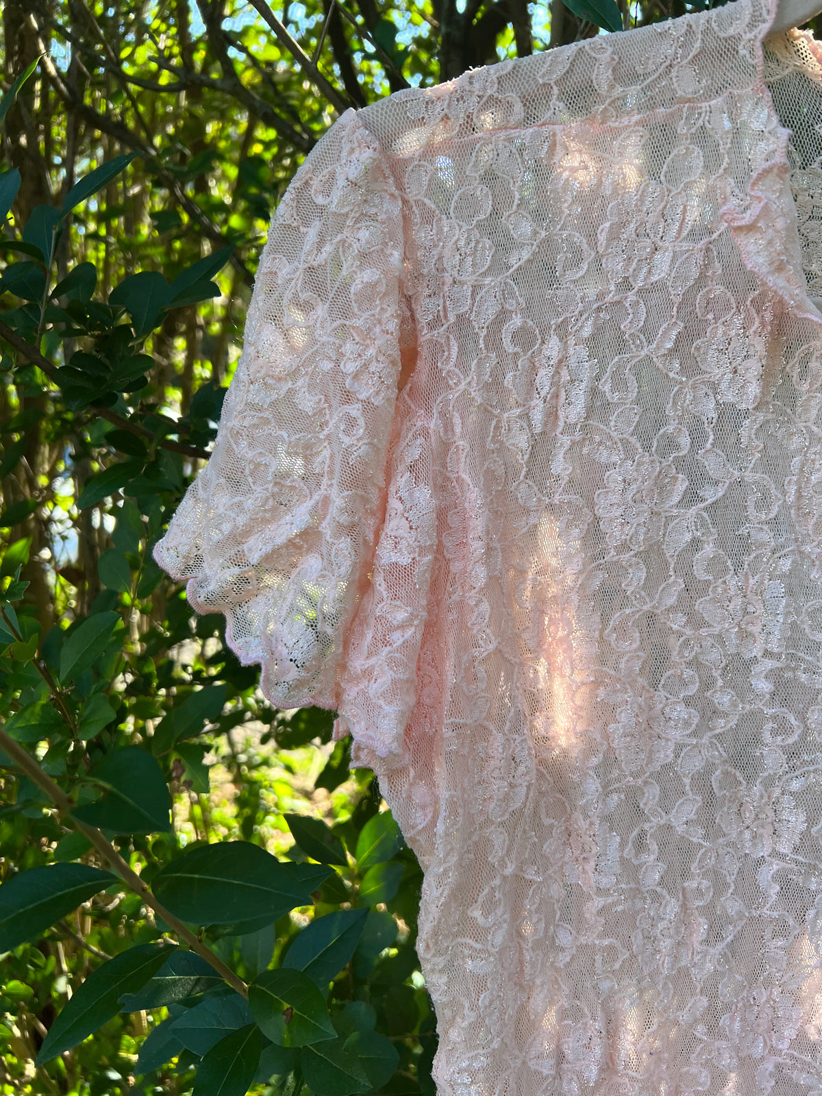 A pale blush pink lace blouse with short flutter sleeves vintage